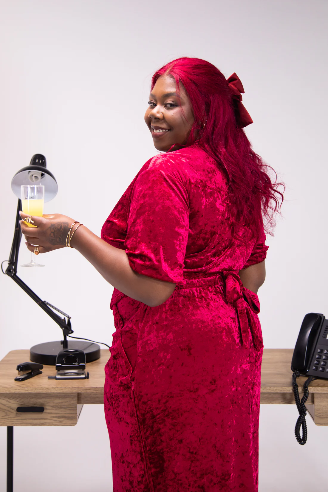 Woman wears crushed velvet red wrap dress